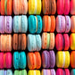 Colorful assorted macarons arranged in neat rows, showcasing vibrant pastel and bright shades with smooth textures, representing the Art Puzzle – Macaron Palette Parade – 1000 Piece Jigsaw Puzzle, a beautiful artwork with satin finish, premium quality, dust free, eco-friendly, perfect 1000 piece jigsaw puzzles for adults.